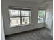 A light-filled carpeted bedroom with large windows overlooking the neighborhood at 3015 Liberty Nw Way, Atlanta, GA 30318
