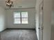 A carpeted bedroom with a window allowing natural light and a modern light fixture at 3015 Liberty Nw Way, Atlanta, GA 30318