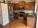 Modern kitchen with stainless steel appliances, granite countertops, and wood cabinets at 3015 Liberty Nw Way, Atlanta, GA 30318