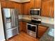 Bright kitchen featuring stainless steel appliances, granite counters, and wood cabinets at 3015 Liberty Nw Way, Atlanta, GA 30318