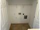 A dedicated laundry room space with tile flooring and utility connections at 3015 Liberty Nw Way, Atlanta, GA 30318