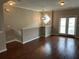 Open-concept living room featuring hardwood floors, neutral walls, and a modern chandelier at 3015 Liberty Nw Way, Atlanta, GA 30318