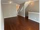 Neutral living room featuring hardwood floors and a staircase in the background at 3015 Liberty Nw Way, Atlanta, GA 30318