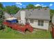 Inviting backyard with a spacious red deck perfect for outdoor dining and relaxation at 3383 Spirit Nw Dr, Kennesaw, GA 30144