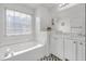 Bright bathroom with a soaking tub, a marble countertop vanity, and decorative accents at 3383 Spirit Nw Dr, Kennesaw, GA 30144