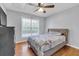 Comfortable bedroom with hardwood floors, a cozy bed, and a large window for natural light at 3383 Spirit Nw Dr, Kennesaw, GA 30144