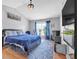 Bright bedroom with vaulted ceiling, wood floors, blue accents and rug, and natural light from the window at 3383 Spirit Nw Dr, Kennesaw, GA 30144