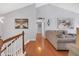Upstairs hallway with hardwood floors and views of the living area at 3383 Spirit Nw Dr, Kennesaw, GA 30144