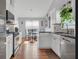 Modern kitchen featuring stainless steel appliances, white cabinets, and wood floors at 3383 Spirit Nw Dr, Kennesaw, GA 30144