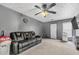 Comfortable living room with plush carpeting, modern ceiling fan, and a cozy black leather sofa at 3383 Spirit Nw Dr, Kennesaw, GA 30144