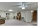 Large carpeted basement featuring an office space, storage cabinets, and access to the staircase at 3871 Lake Juliette Dr, Buford, GA 30519