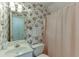Charming bathroom featuring floral wallpaper, a vanity with bright lighting, and a shower curtain at 3871 Lake Juliette Dr, Buford, GA 30519