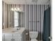 Clean bathroom featuring striped wallpaper, a white vanity, toilet, and a shower with curtain at 3871 Lake Juliette Dr, Buford, GA 30519
