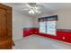 Bedroom with a red accent wall and a window with patterned valances at 3871 Lake Juliette Dr, Buford, GA 30519