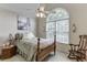 Bedroom featuring a ceiling fan and a large arched window at 3871 Lake Juliette Dr, Buford, GA 30519