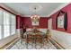 Formal dining room with elegant chandelier and wainscoting at 3871 Lake Juliette Dr, Buford, GA 30519