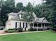 Charming home with a large front yard and a covered front porch perfect for relaxing at 3871 Lake Juliette Dr, Buford, GA 30519