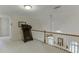 Loft with a railing overlooking the lower floor and including a treadmill at 3871 Lake Juliette Dr, Buford, GA 30519
