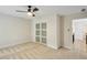 Bright bedroom features sliding closet doors, carpet flooring, ceiling fan, and neutral walls at 545 Woodman Pl, Roswell, GA 30076