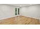 Bright bedroom with hardwood floors and a large window offering plenty of natural light at 545 Woodman Pl, Roswell, GA 30076