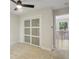Bright bedroom featuring carpet floors, modern fan, and sliding closet doors at 545 Woodman Pl, Roswell, GA 30076