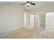 Bright bedroom featuring neutral walls, carpet floors, modern fan, and closet with sliding doors at 545 Woodman Pl, Roswell, GA 30076