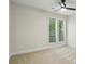 Neutral bedroom with carpet flooring, ceiling fan, and large windows allowing natural light at 545 Woodman Pl, Roswell, GA 30076