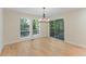 Bright dining room features hardwood floors, modern chandelier, and sliding doors to deck at 545 Woodman Pl, Roswell, GA 30076