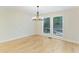 Light hardwood flooring and natural lighting in a traditional dining room space at 545 Woodman Pl, Roswell, GA 30076