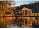 Scenic view of a wooden gazebo on a dock, reflecting in the calm lake water at 545 Woodman Pl, Roswell, GA 30076
