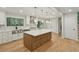 Spacious kitchen features a large island, stainless steel appliances and hardwood floors at 545 Woodman Pl, Roswell, GA 30076