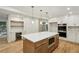 Spacious kitchen with a large island, stainless steel appliances, custom cabinets and hardwood floors at 545 Woodman Pl, Roswell, GA 30076