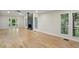 Bright living room features hardwood floors, a modern fireplace, and large windows at 545 Woodman Pl, Roswell, GA 30076