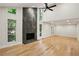 Bright living room featuring hardwood floors, lots of natural light, and a modern fireplace at 545 Woodman Pl, Roswell, GA 30076