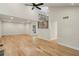 Spacious living room with beautiful hardwood floors and a modern ceiling fan at 545 Woodman Pl, Roswell, GA 30076