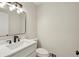 Clean powder room features a modern vanity, lighting fixture, and sink at 545 Woodman Pl, Roswell, GA 30076