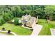 Aerial view of a traditional two-story home, backyard pool and lush landscaping at 116 Archstone Sq, Mcdonough, GA 30253