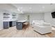 Spacious finished basement with wet bar, counter seating, and comfortable white sectional seating at 116 Archstone Sq, Mcdonough, GA 30253