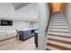 Basement featuring a staircase, an island, and a large sectional at 116 Archstone Sq, Mcdonough, GA 30253