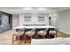 Finished basement features a large wet bar with counter seating and decorative shelving at 116 Archstone Sq, Mcdonough, GA 30253