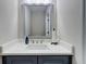 Modern bathroom with gray vanity, white countertop, and large framed mirror at 116 Archstone Sq, Mcdonough, GA 30253