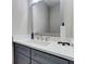 Bathroom featuring gray vanity with a white countertop and a large framed mirror at 116 Archstone Sq, Mcdonough, GA 30253