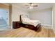 Cozy bedroom features a ceiling fan, wood floors and a walk-in closet at 116 Archstone Sq, Mcdonough, GA 30253