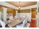 Elegant dining room featuring hardwood floors, wainscoting and an elegant chandelier at 116 Archstone Sq, Mcdonough, GA 30253