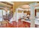 Formal dining room with wainscoting, elegant chandelier, hardwood floors and staircase at 116 Archstone Sq, Mcdonough, GA 30253