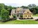 Charming two-story home featuring a well-manicured lawn, complemented by lush landscaping, a backyard pool and a stone facade at 116 Archstone Sq, Mcdonough, GA 30253