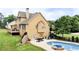 Beautiful home exterior with a deck, pool, and well-maintained lawn, offering a luxurious outdoor experience at 116 Archstone Sq, Mcdonough, GA 30253