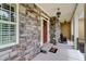Charming front porch with stone accents, offering a welcoming entrance to the home at 116 Archstone Sq, Mcdonough, GA 30253