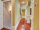 Hallway featuring hardwood floors, white columns, and access to additional spaces at 116 Archstone Sq, Mcdonough, GA 30253