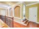 Upstairs hallway features hardwood floors, decorative railings, and an open view to living area at 116 Archstone Sq, Mcdonough, GA 30253